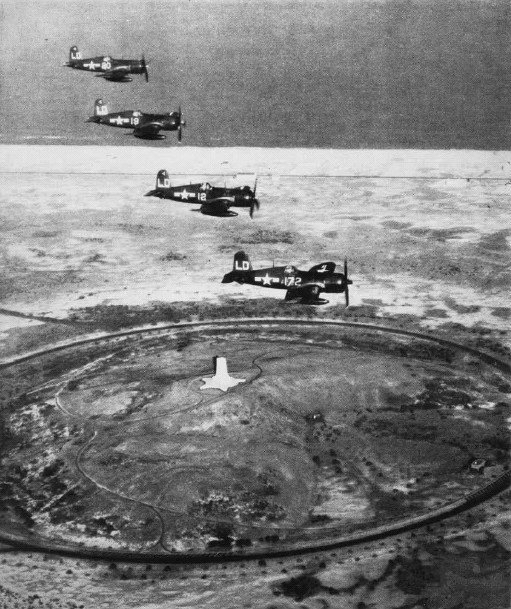 F4U-4 Corsair fighters of US Marine Corps squadron VMF-212 in flight over Wright Memorial, Kitty Hawk, North Carolina, United States, 17 Dec 1948; seen in Feb 1949 issue of US Navy publication Naval Aviation News