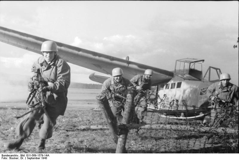 German glider troopers in exercise, charging from a DFS 230 glider upon landing, Italy, Sep 1943