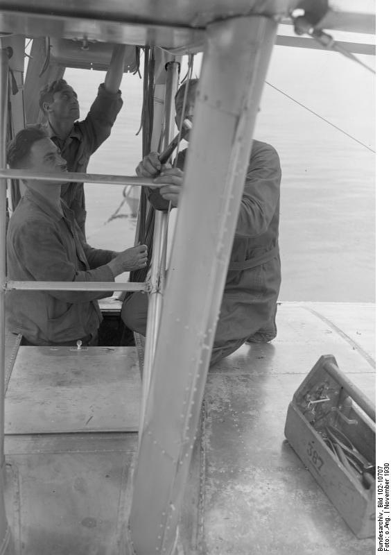 Engineers inspecting the support rails of Do X aircraft, Amsterdam, the Netherlands, Nov 1930