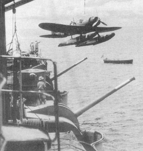 Japanese E13A seaplane being craned onto cruiser Kinugasa, 1940s; note Type 10 120mm guns in foreground