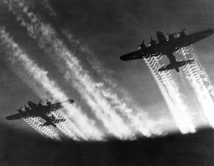 Two B-17 Flying Fortresses' vapor trails light up the night sky over Eastern Europe, circa 1945