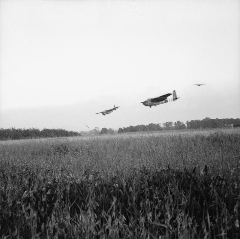Hamilcar gliders carrying light armored vehicles coming into landing near Ranville, France, afternoon of 6 Jun 1944; note gliders' steep angle of approach