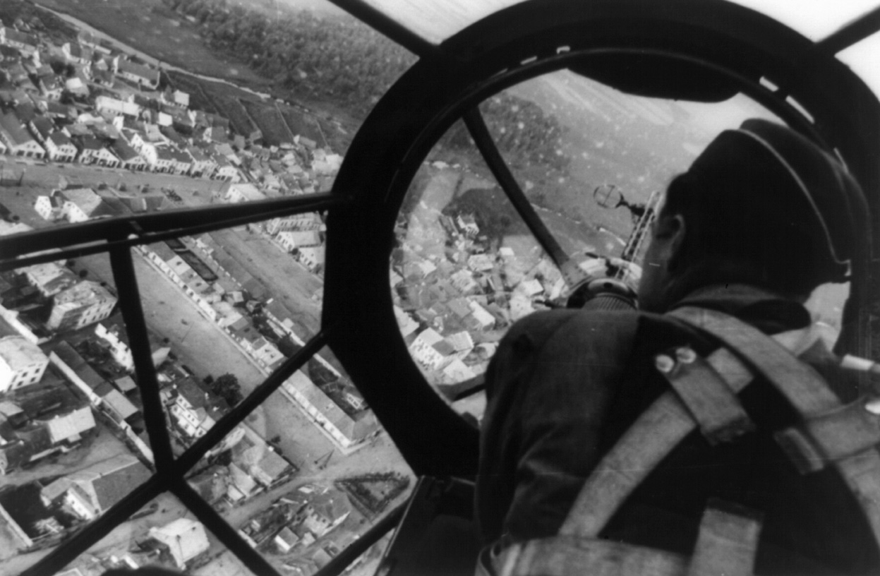 Aerial view of a Polish city through the gunner's station aboard a German He 111 bomber, Sep 1939