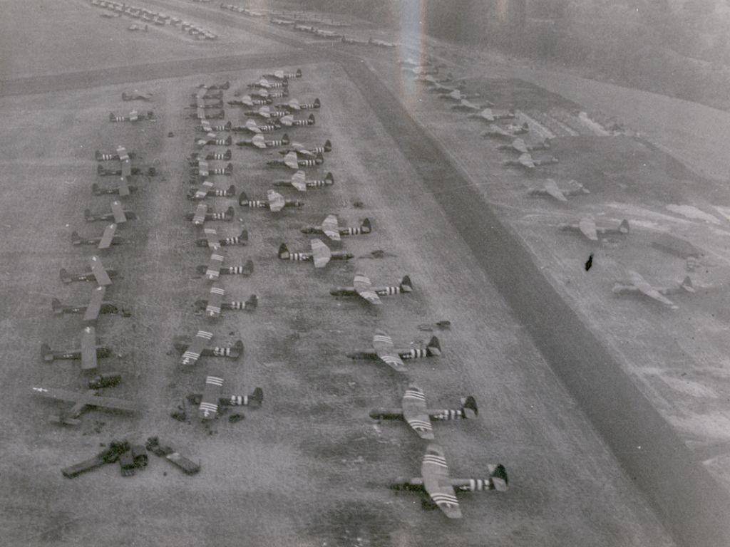CG-4A and Horsa gliders at an English airfield preparing for the Normandy invasion, May 1944; note the application of invasion stripes still in-progress