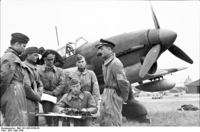 German pilots being briefed before a mission, Arras, France, May 1940; note Ju 87 Stuka aircraft in background
