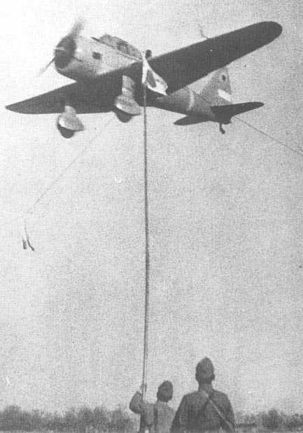 Ki-36 aircraft in flight over an airfield, circa 1940s