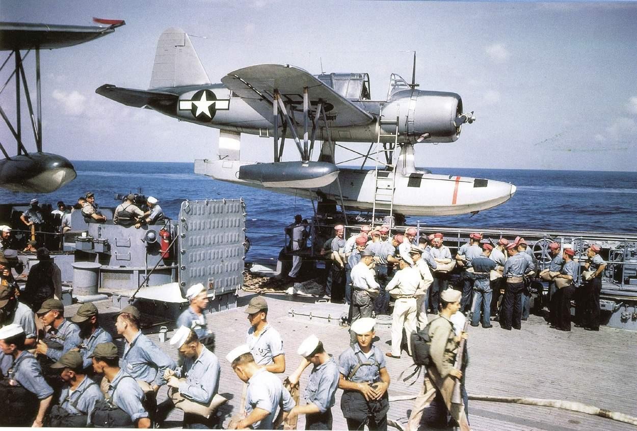 Crew of battleship Missouri performing abandon ship drills, summer 1944; note OS2N-1 Kingfisher aircraft in background on port side catapult