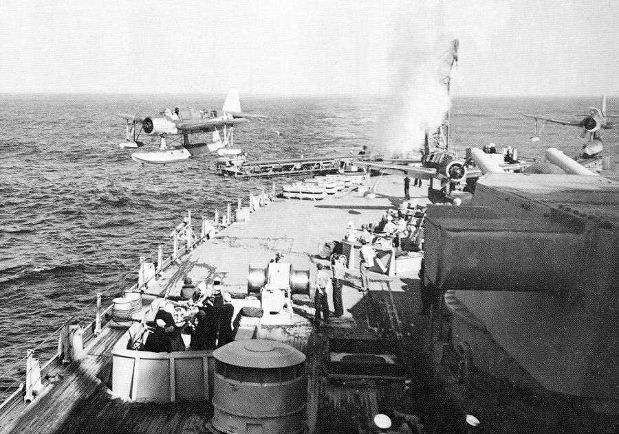 Battleship USS Iowa launching one of her Vought OS2U Kingfisher float planes while two others remained on their catapults, location unknown, 1944