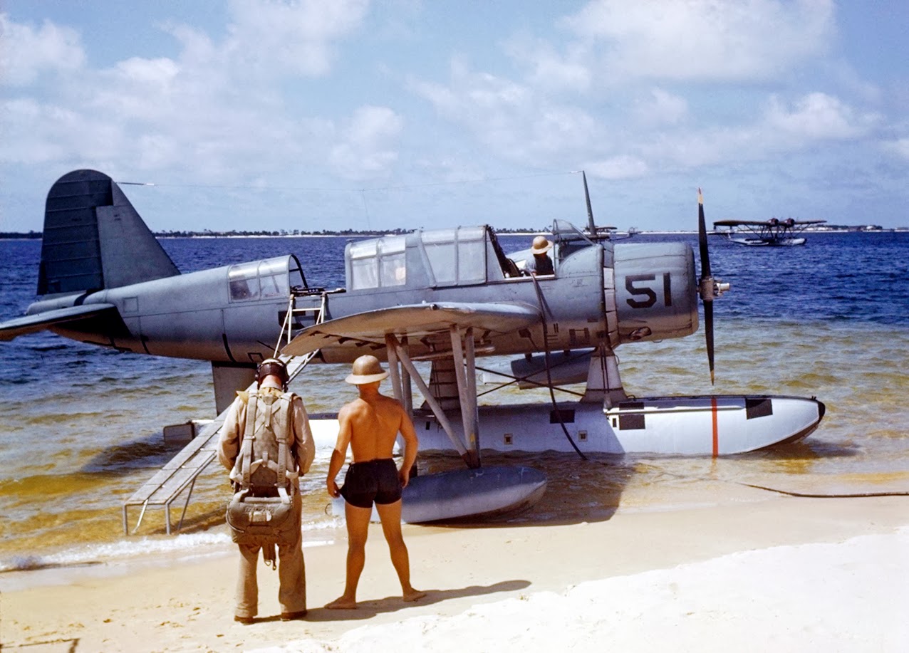 OS2U Kingfisher at the edge of the seaplane ramp at NAS Pensacola, Florida, United States, early 1941. Note Consolidated P2Y flying boat laying off shore, photo 2 of 2 (color)