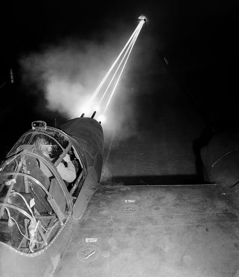 Nose guns of a P-38 Lightning aircraft lighting up the night sky as an armorer test-fired weapons after routine maintenance, date unknown