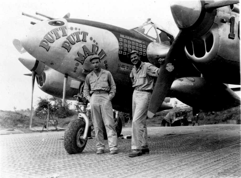 USAAF pilots Colonel MacDonald and Al Nelson in the Pacific Ocean with MacDonald's P-38J Lightning aircraft 'Putt Putt Maru', 1944