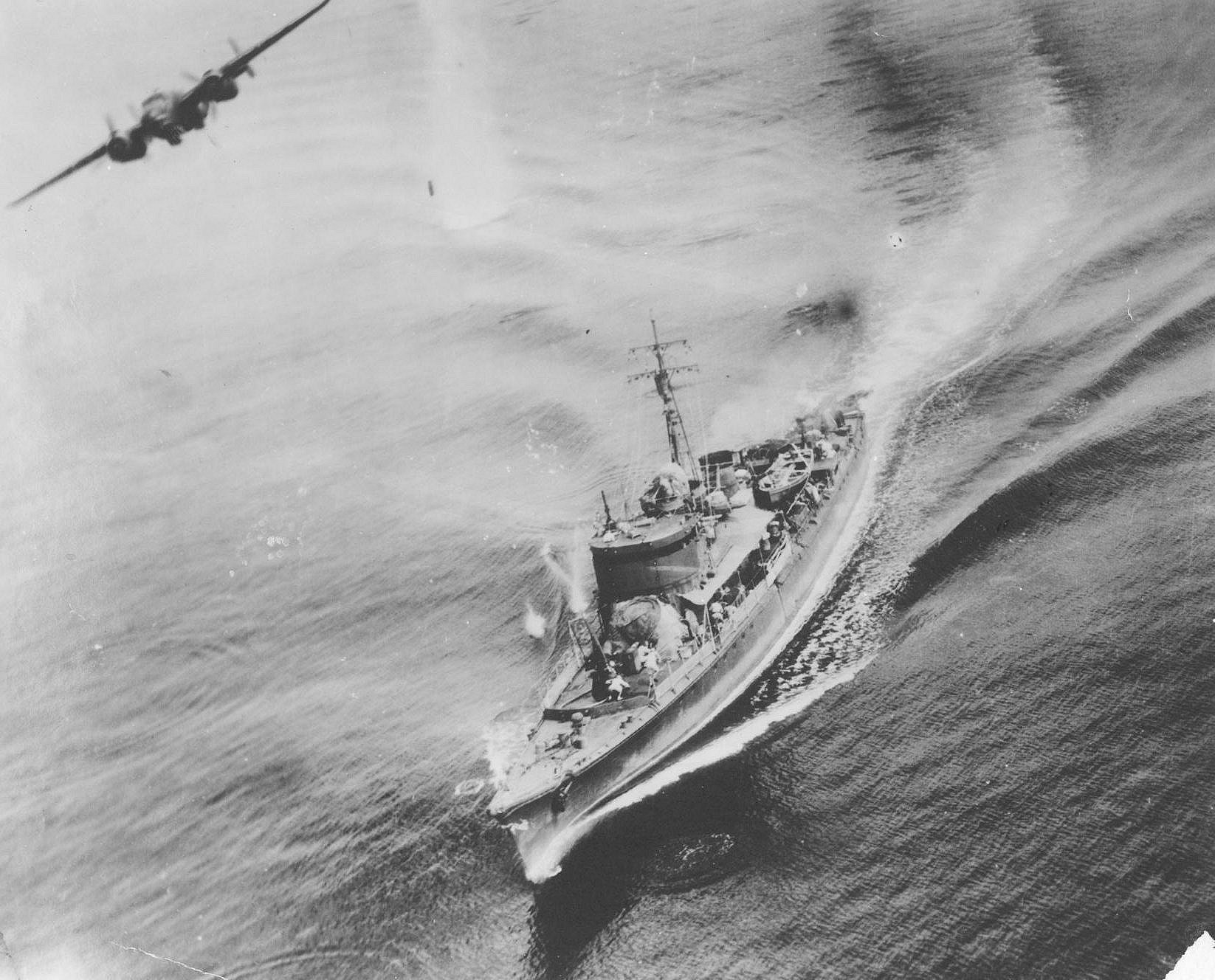 B-25 aircraft of 345th Bombardment Group, US 500th Bombardment Squadron attacking Japanese Sub Chaser CH-39 off Three Island Harbor, New Hanover, New Ireland, 16 Feb 1944, 2 of 3; note bomb in flight