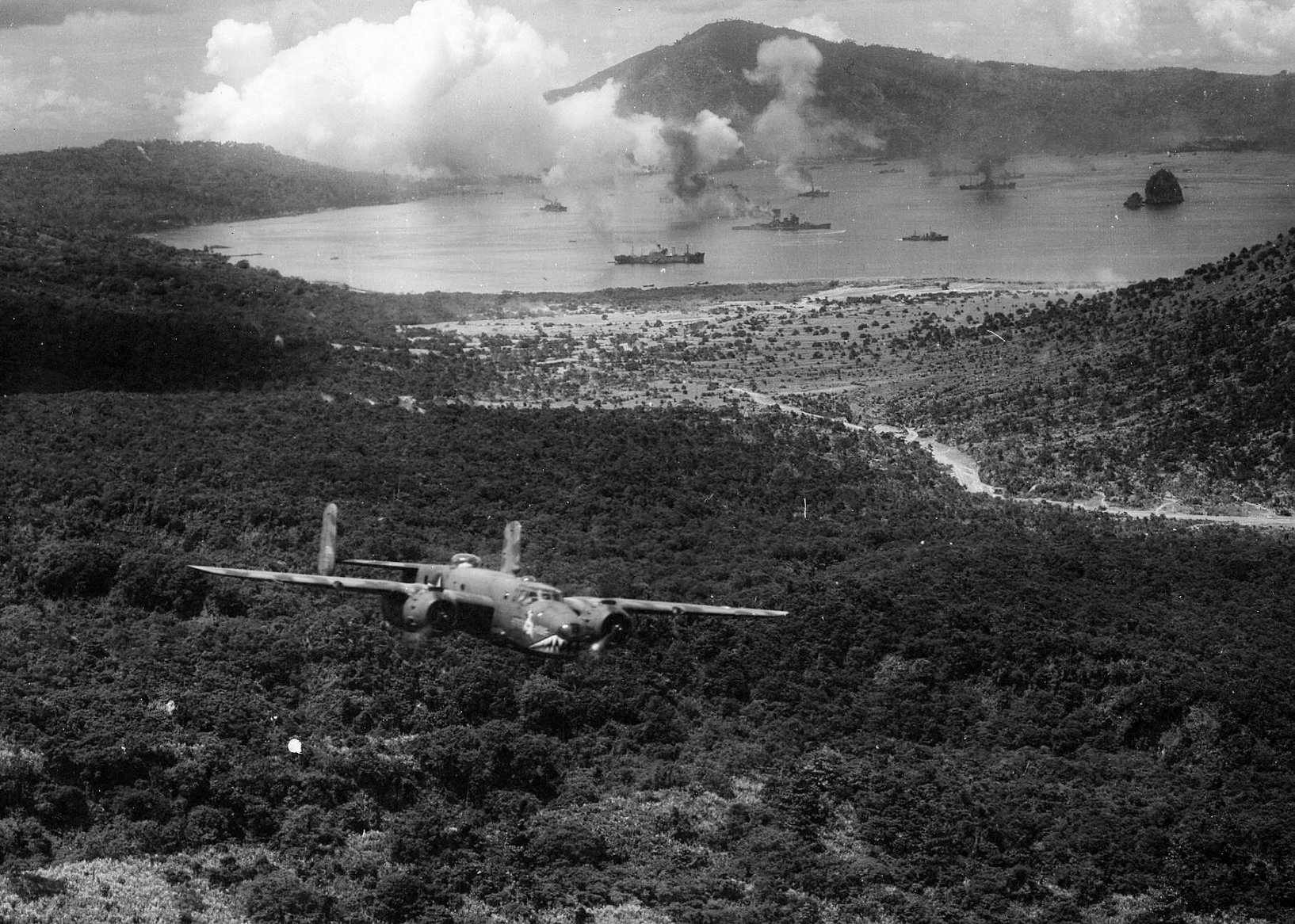 US B-25D Mitchell bomber 'Here's Howe' of the 'Grim Reapers' 3rd Bombardment Group, 'Pair-O-Dice' 90th Bombardment Squadron executing a low level attack on Japanese shipping, Rabaul, New Britain, Nov 2 1943