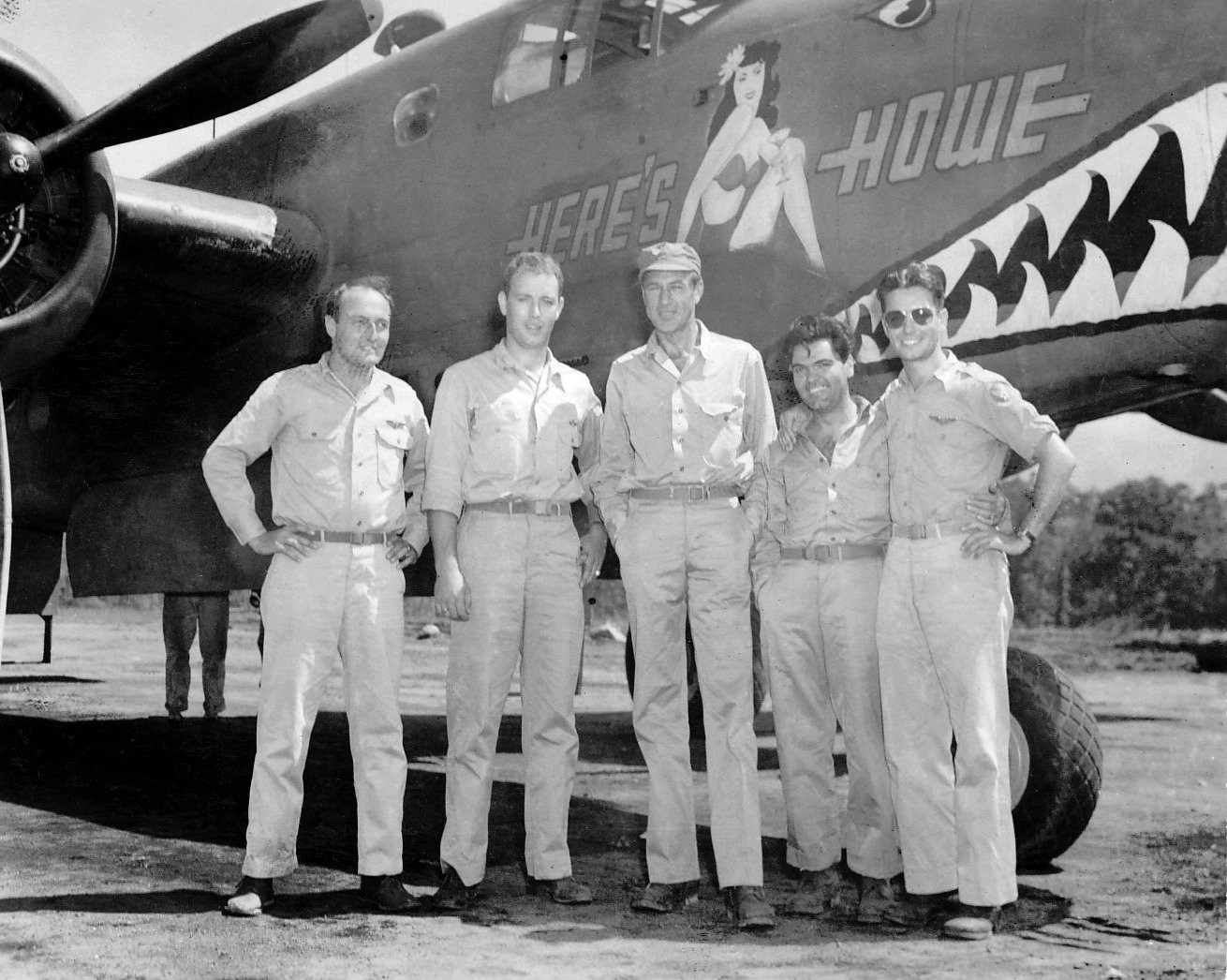 Actor Gary Cooper with pilots of 90th Squadron of USAAF 3rd Bomb Group and B-25D bomber 'Here's Howe', Dobodura Airfield, Australian Papua, mid-1943