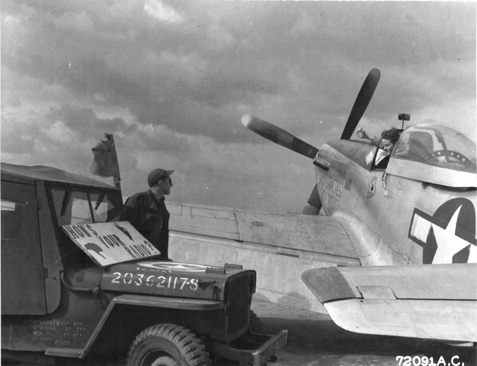 Ground crew made an 'on the line' check of the radio in the P-51 Mustang 'Hot Shot Charlies' of the 364th Fighter Group, US 383rd Fighter Squadron, RAF Honnington, England, United Kingdom, 5 Apr 1945