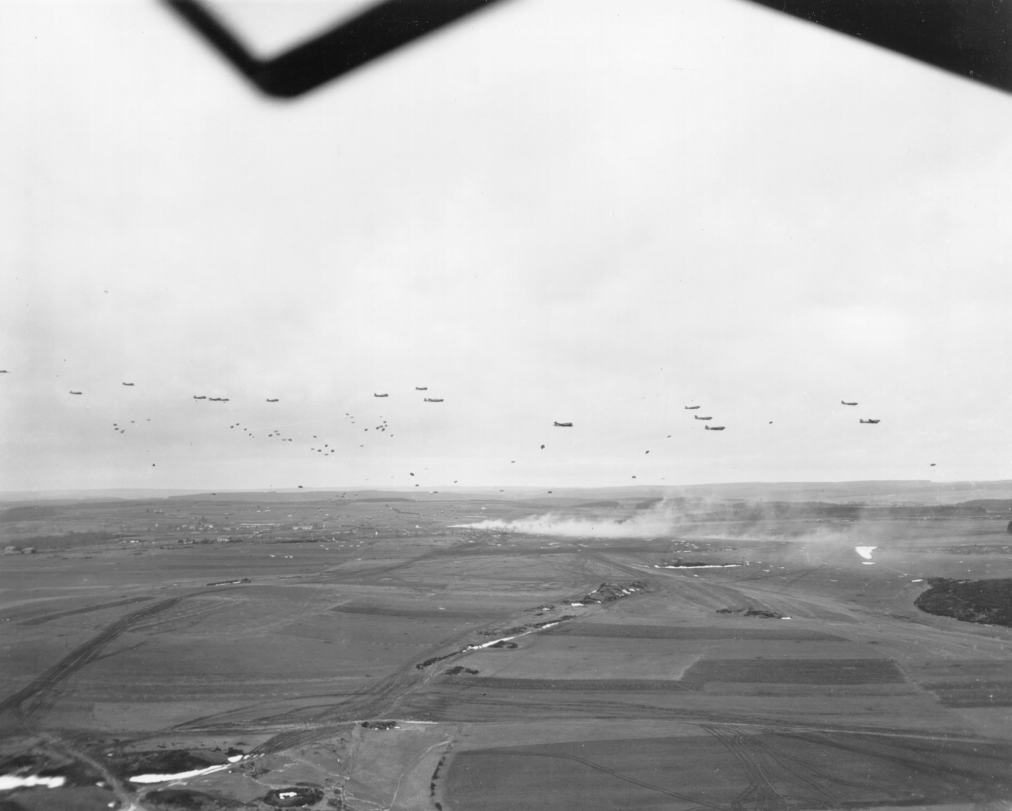 C-47 Skytrain aircraft of US 101st Airborne Division dropping supplies to troops of US 4th Division, Briealf, Germany, 13 Feb 1945