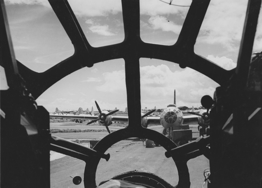 View of a fleet of B-29 bombers through the nose of another B-29 bomber, Saipan, Mariana Islands, 1945