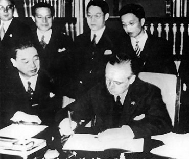 Joachim von Ribbentrop signing the Anti-Comintern Pact, Berlin, Germany, 25 Nov 1936; Japanese ambassador to Berlin Kintomo Mushakoji watching