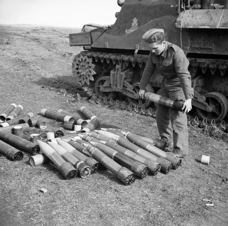 British soldier preparing ammunition for a M7 Priest self-propelled gun, Anzio, Italy, 31 Jan 1944