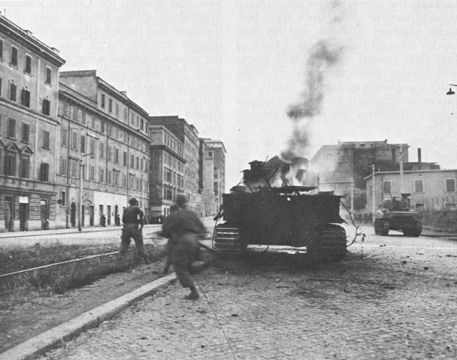 US infantry running past a burning tank, Rome, Italy, 4 Jun 1944