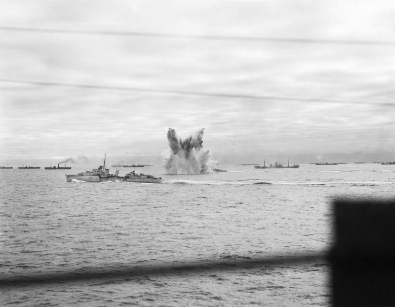 A German bomb detonating underwater near HMS Ashanti, HMS Wheatland, and HMS Eskimo which were escorting Allied convoy PQ-18, Sep 1942