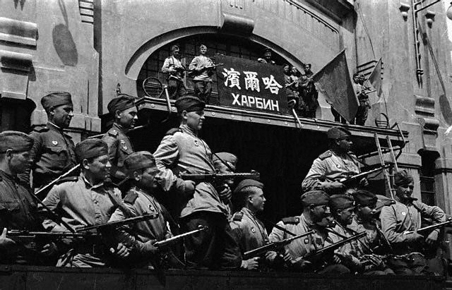 Soviet troops flying the red flag atop the train station at Harbin, Songjiang, China, circa 20 Aug 1945, photo 2 of 2