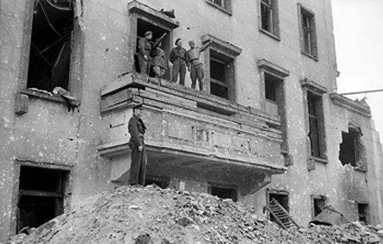 British and Soviet soldiers on the balcony of the Old Reich Chancellery building, same spot where Adolf Hitler had made many of his speeches, Berlin, Germany, 5 Jul 1945