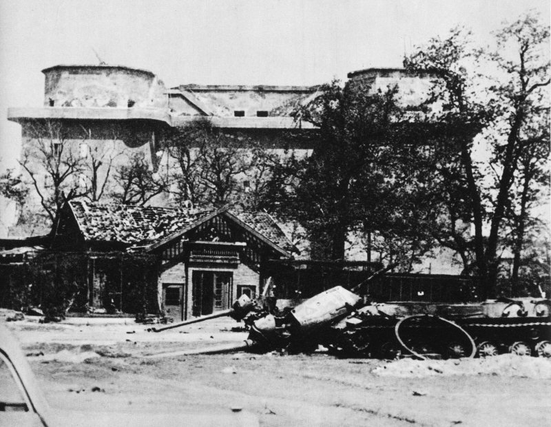 The Berlin Zoo flak tower after the battle, Germany, 1945; note two destroyed IS-2 tanks in foreground