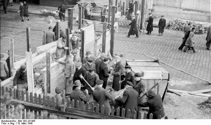 German Volkssturm soldiers and civilians building a roadblock in Berlin, Germany, 10 Mar 1945