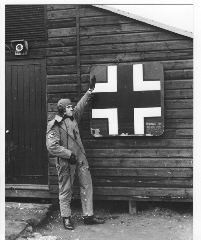 British pilot Barrie Heath of No. 611 Squadron RAF posing with a piece of downed German aircraft, 1941