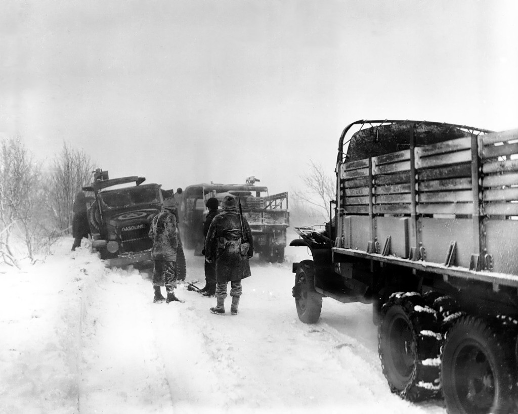 Men of the US 1st Infantry Division checking out a gasoline truck that had skidded off the road due to snow and ice, Sourbrodt, Belgium, 19 Jan 1945
