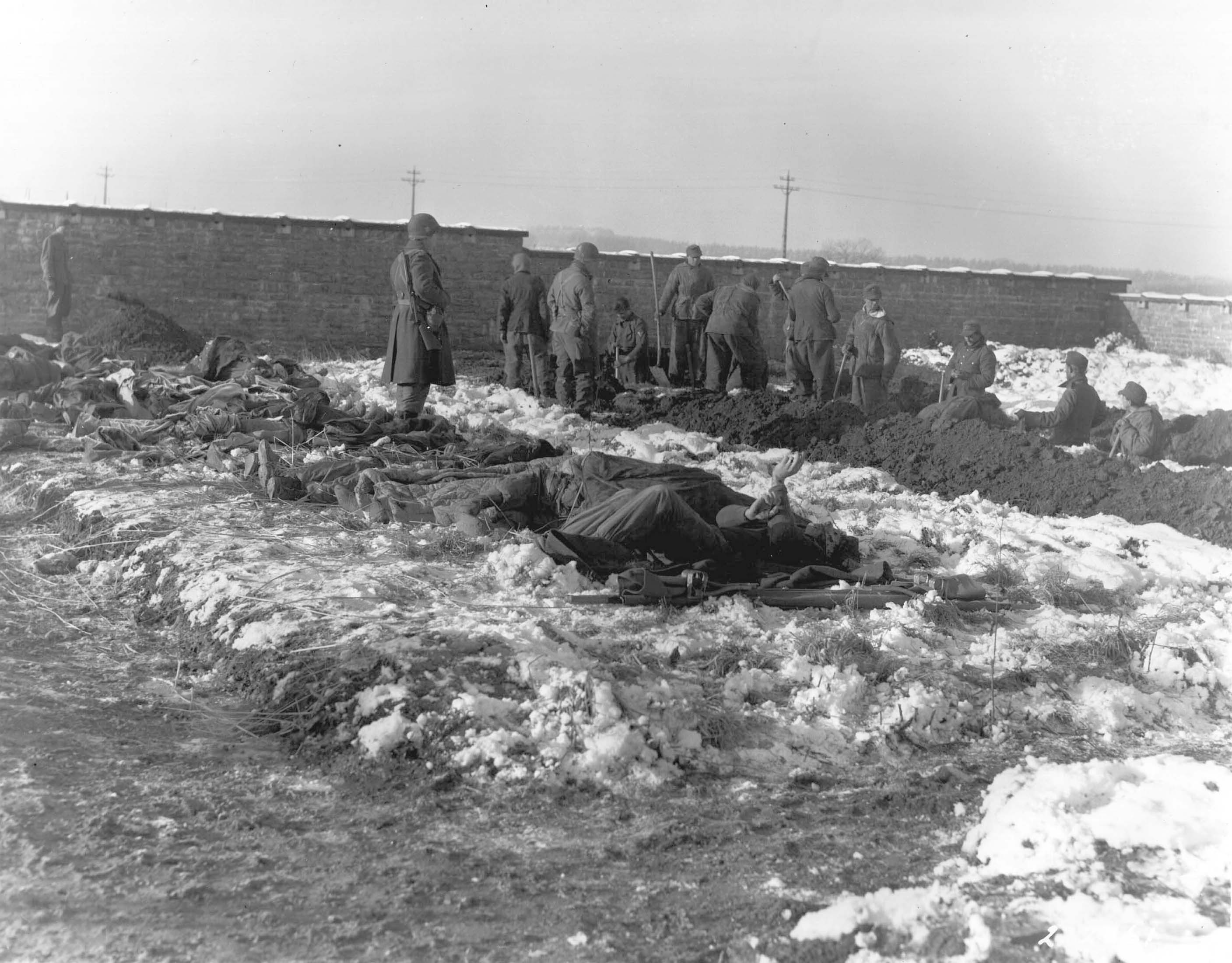 German prisoners of war digging graves for killed men of US 101st Airborne Division, near Bastogne, Belgium, late Dec 1944