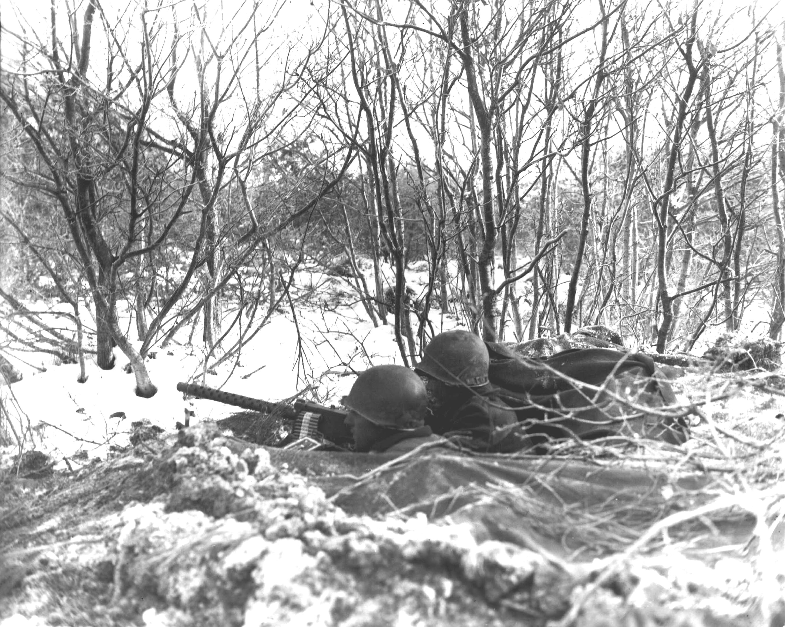 Machine gun post manned by men of 1st Battalion, 157th Regiment, US 45th Division, Niederbronn-les-Bains, France, 10 Dec 1944; note M1919 Browning machine gun