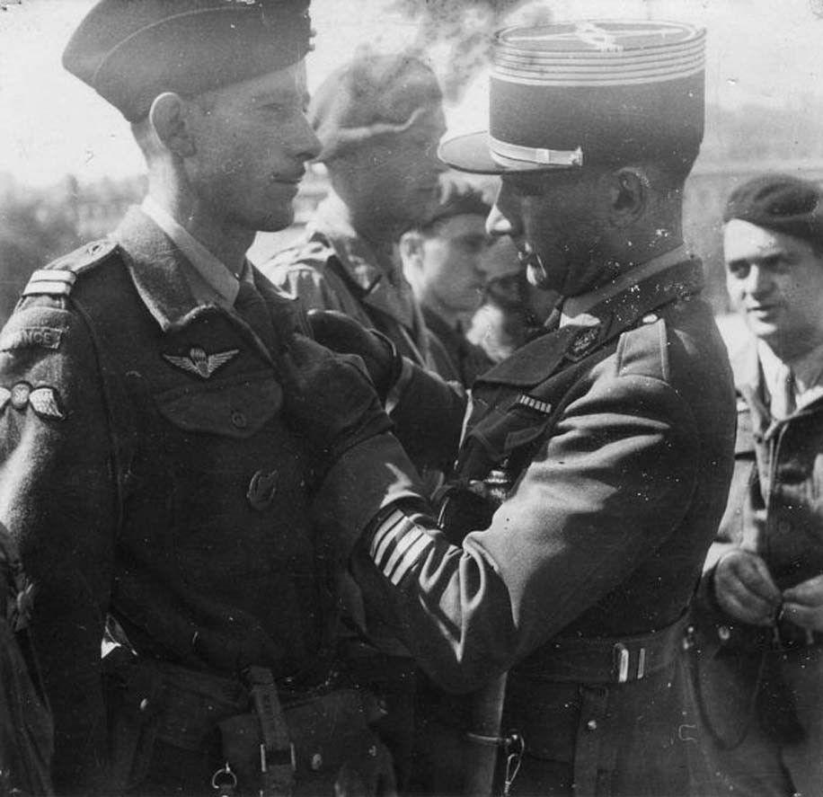 A French Army colonel awarding Operation Jedburgh personnel Jean Larrieu the Croix de Guerre with Palm, Place Bellecour, Lyon, France, 5 Sep 1944