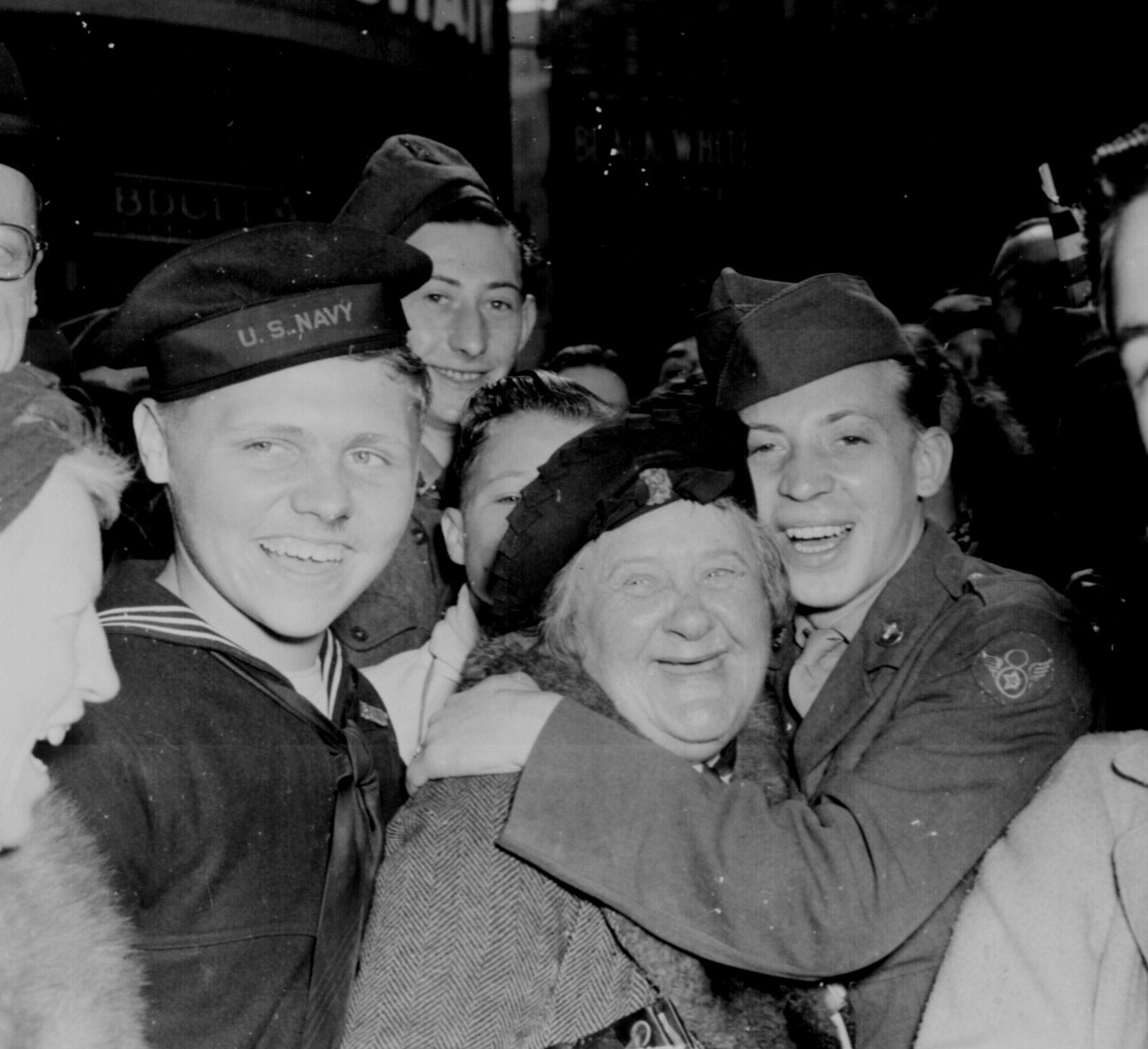 A jubilant American airman hugging an English woman at Piccadilly Circus, London, England, United Kingdom, celebrating Germany's unconditional surrender, 7 May 1945