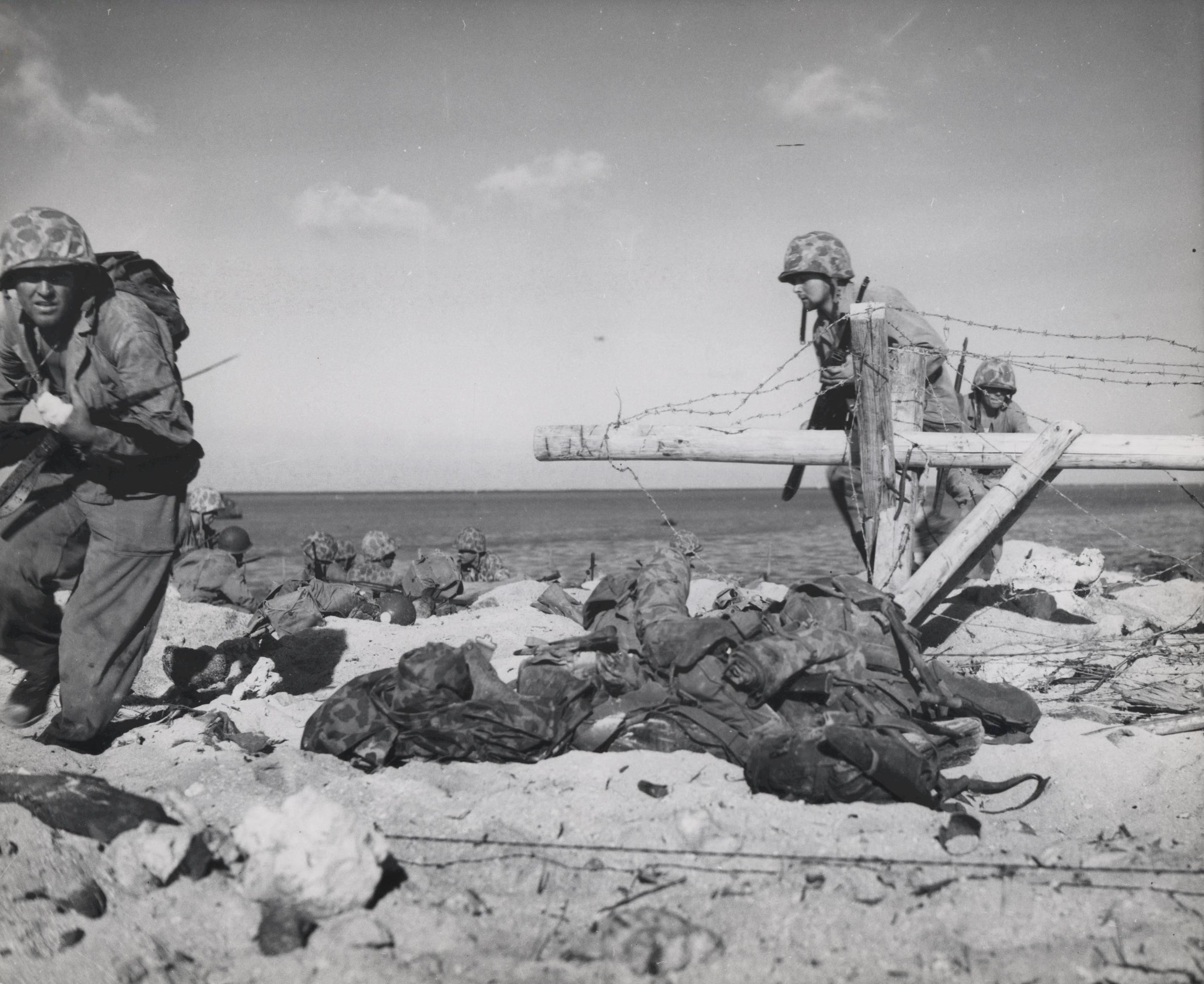 American Marines negotiating Japanese-laid barb wire, Betio, Tarawa Atoll, 21 Nov 1943