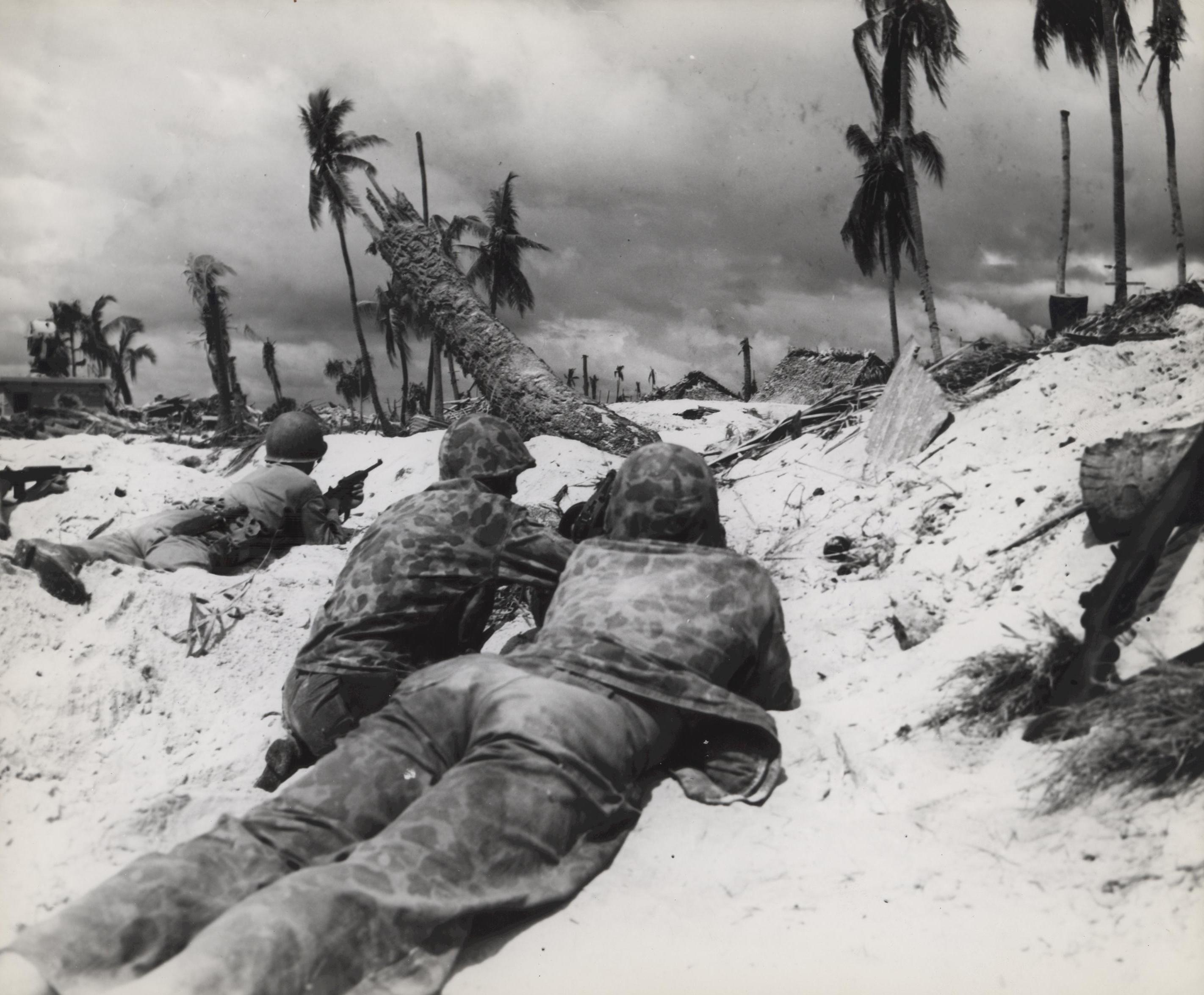 US Marines in prone position on the landing beach at Tarawa, Gilbert Islands, 20 Nov 1943, photo 1 of 2