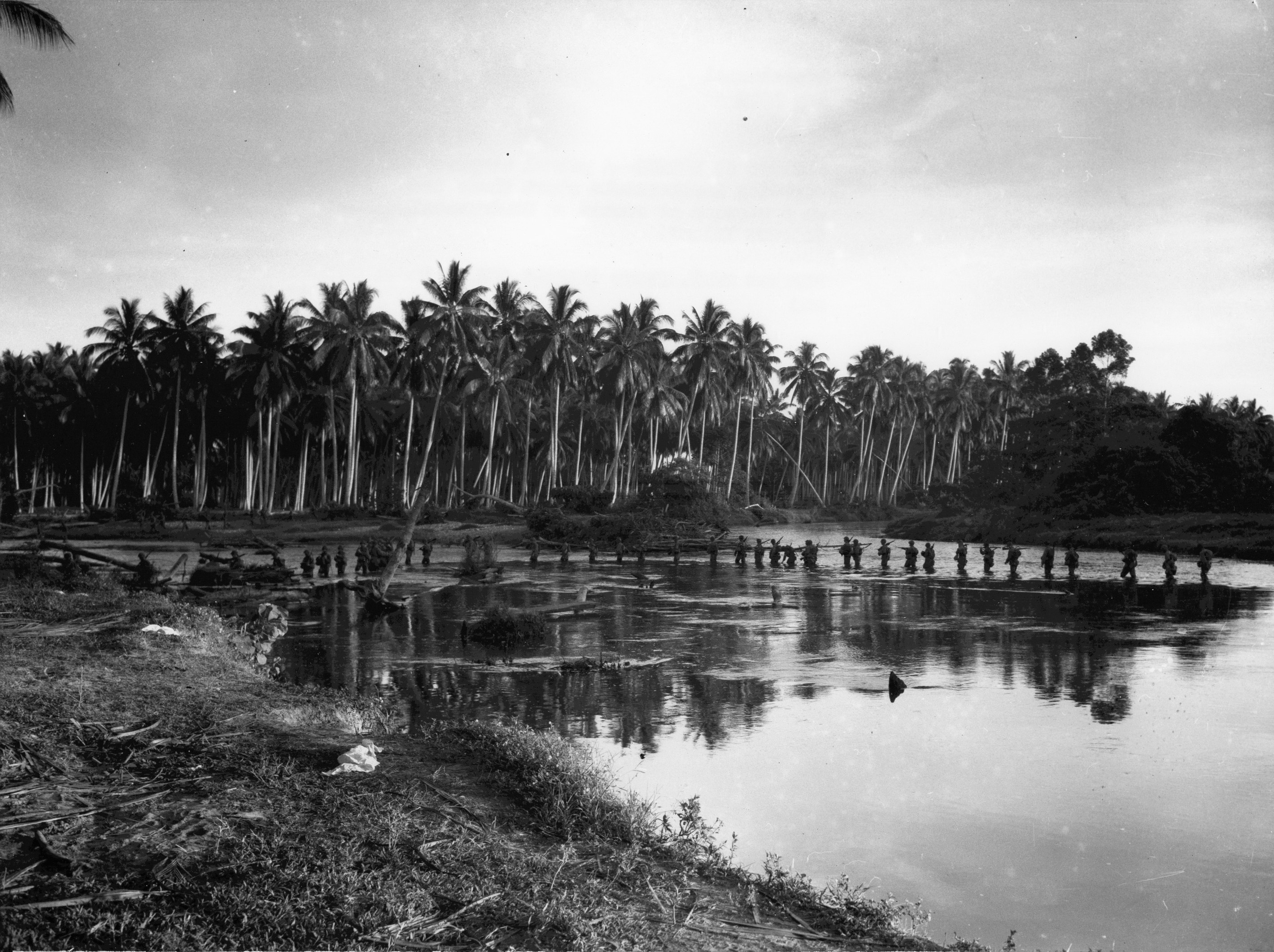Men of US 2nd Marine Division wading through shallow water, Guadalcanal, Solomon Islands, Aug 1942