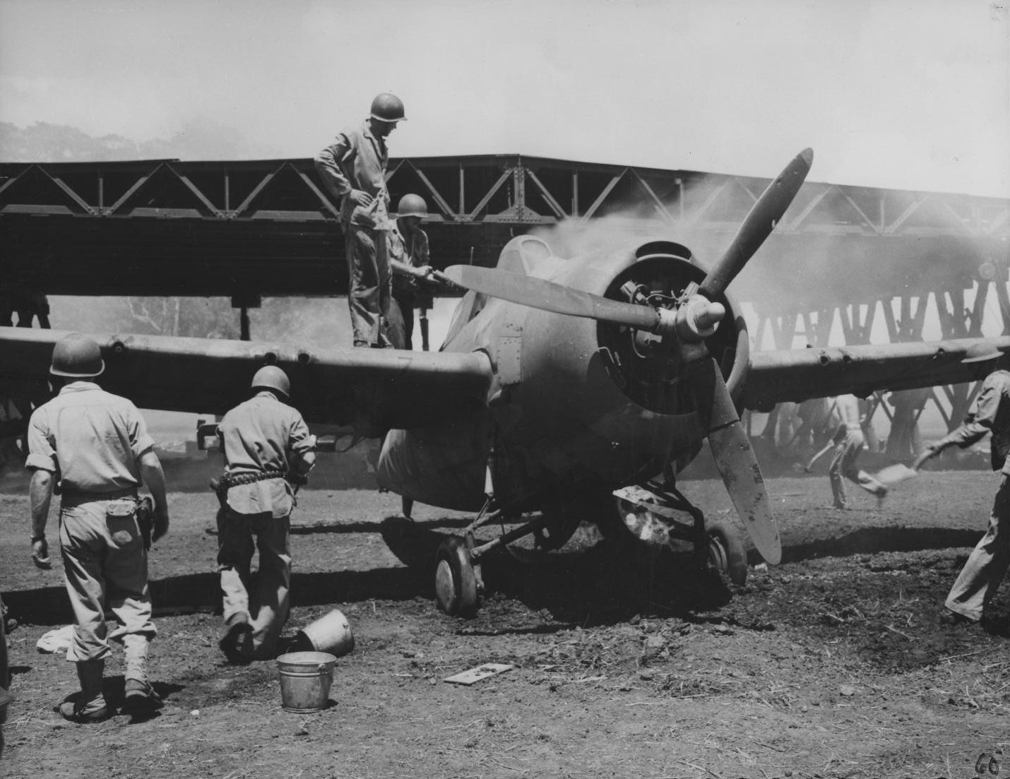 US Marine ground crew putting out a fire on a Wildcat fighter, Henderson Field, Guadalcanal, Solomon Islands, 1942
