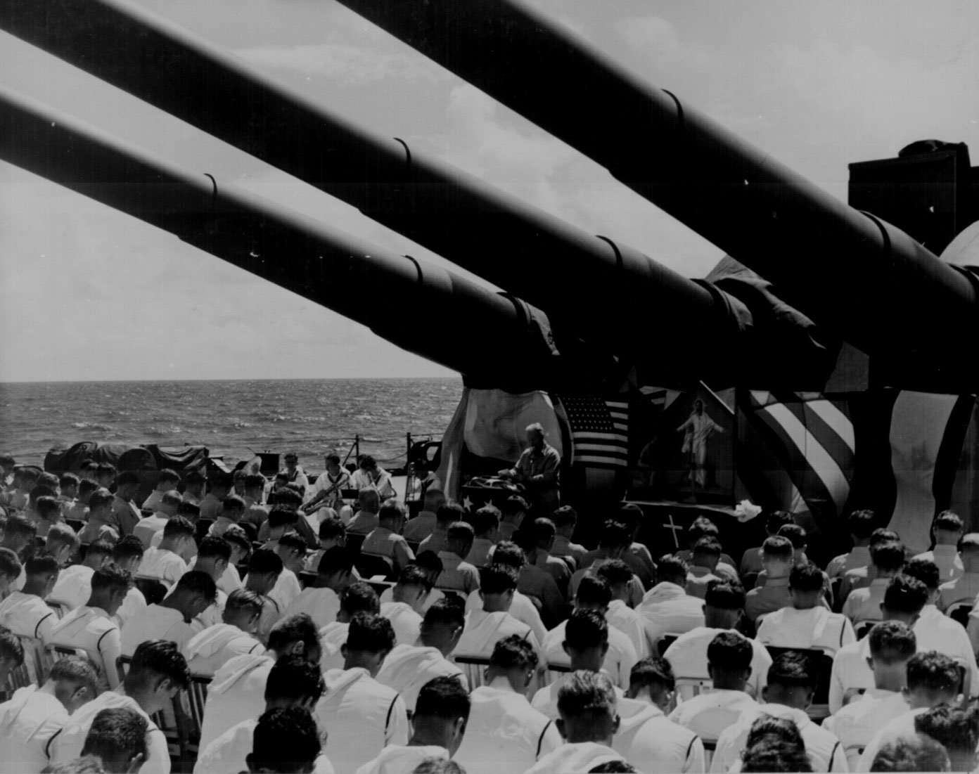 US Navy Chaplain N. D. Lindner leading a memorial service aboard USS South Dakota for men lost to air attacks, off Guam, 1 Jul 1944