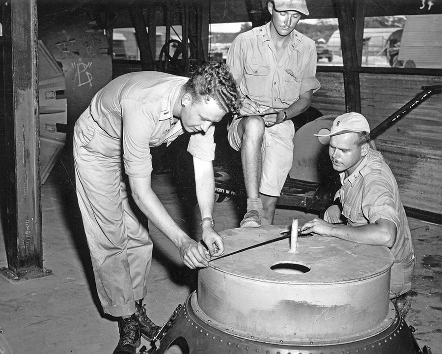 US personnel checking an atomic bomb casing, Tinian, Mariana Islands, 1945