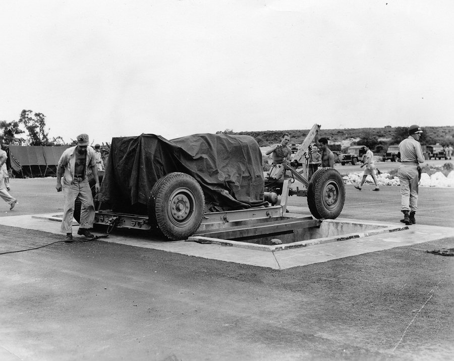 Lowering 'Fat Man' bomb into a bomb pit at the airfield on Tinian, Mariana Islands, Aug 1945, photo 2 of 5