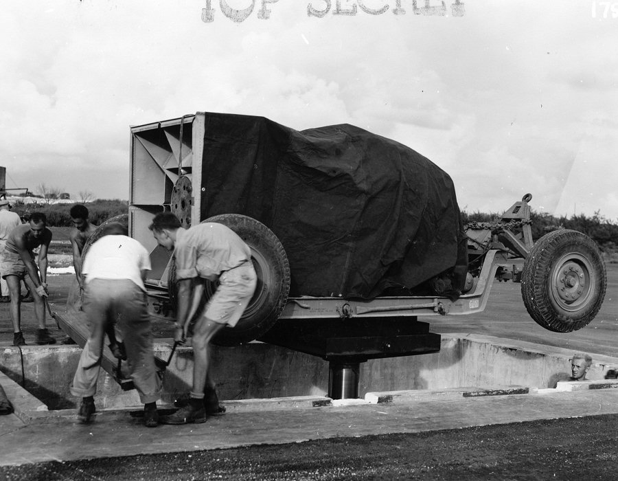 Lowering 'Fat Man' bomb into a bomb pit at the airfield on Tinian, Mariana Islands, Aug 1945, photo 3 of 5