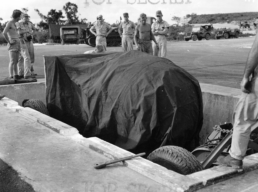 Lowering 'Fat Man' bomb into a bomb pit at the airfield on Tinian, Mariana Islands, Aug 1945, photo 5 of 5