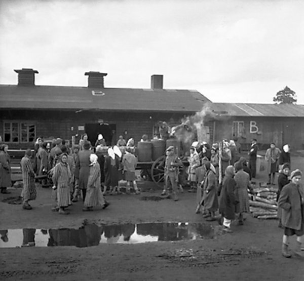 British soldiers supervised the distribution of food to former inmates of Bergen-Belsen Concentration Camp, Germany, 21 Apr 1945