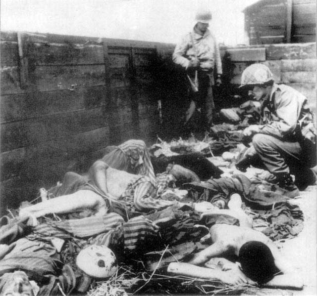 American soldiers inspecting a train car full of dead prisoners at Dachau Concentration Camp, Germany, circa May 1945