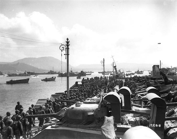 Allied soldiers and vehicles waited to be loaded prior to a practice landing, possibly for the invasion of Southern France, held near Mondragone, Italy, 31 Jul 1944