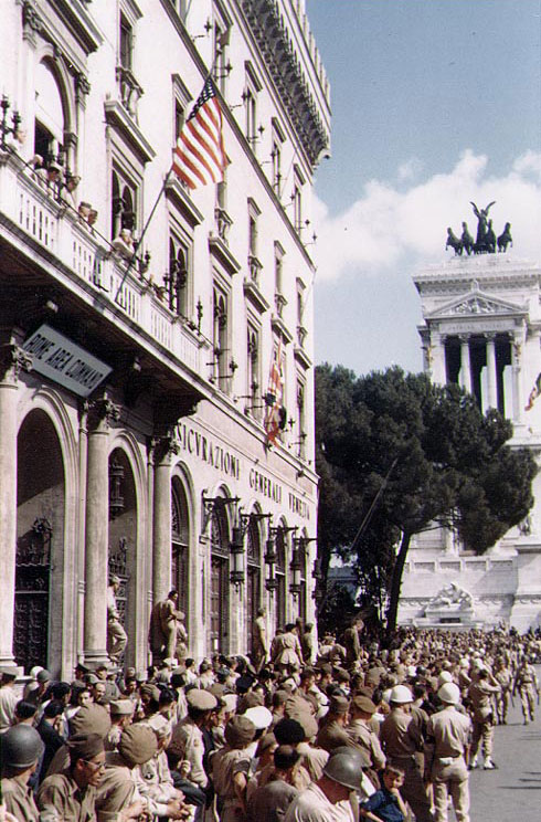 American troops in Rome, circa Jun 1944; note the 'Rome Area Command' building on left and Victor Emmanuel II Monument in background