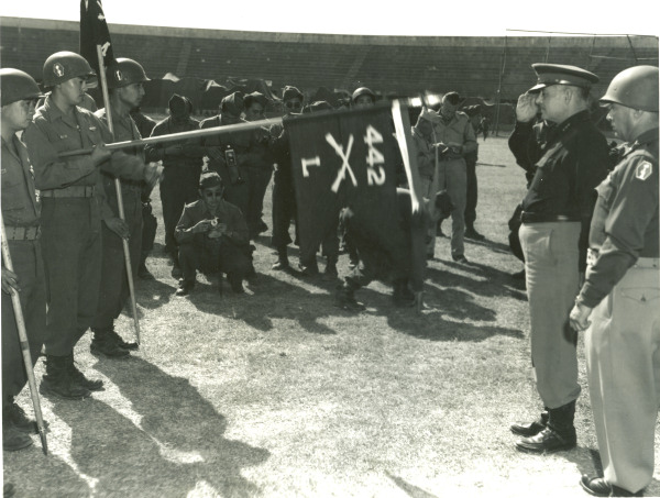 US Army Lieutenant General Lucian Truscott of 5th Army saluting guidon of Co. L, 3rd Btn, 442nd RCT, Livorno, Italy, 4 Sep 1945; note Presidential Unit Citation banner on guidon