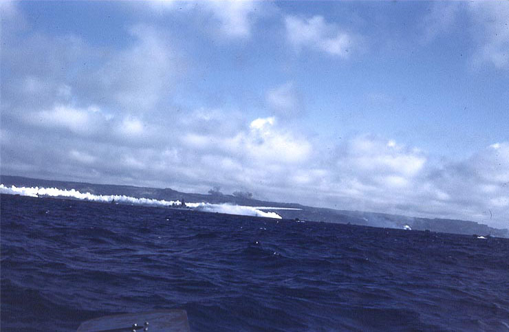 Ships making smoke screen off Iwo Jima per original caption, but appearance of battleship Colorado or Maryland in a photo of this set indicate it might have been Okinawa; circa 1945, photo 1 of 2